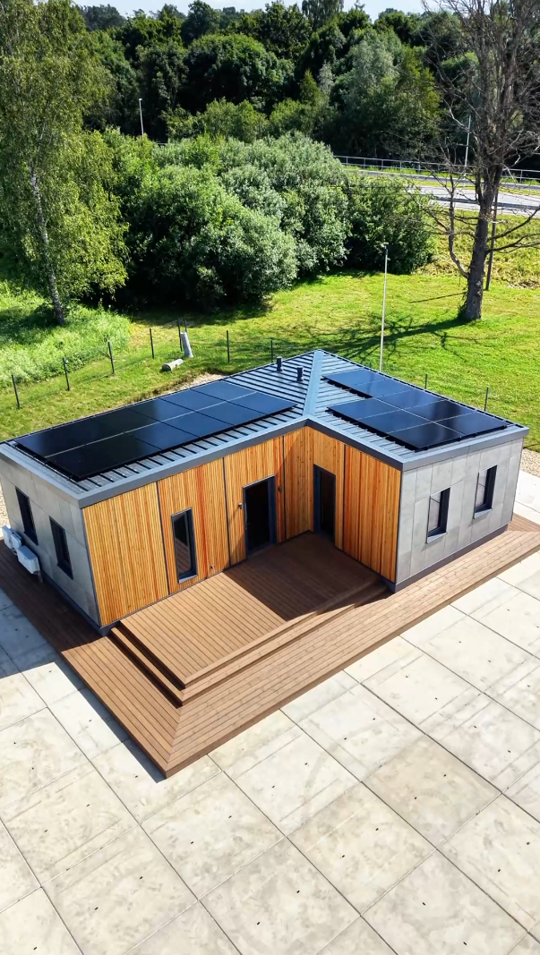 TheHouz L-Shape S modular show home, aerial drone view with solar roof and timber deck