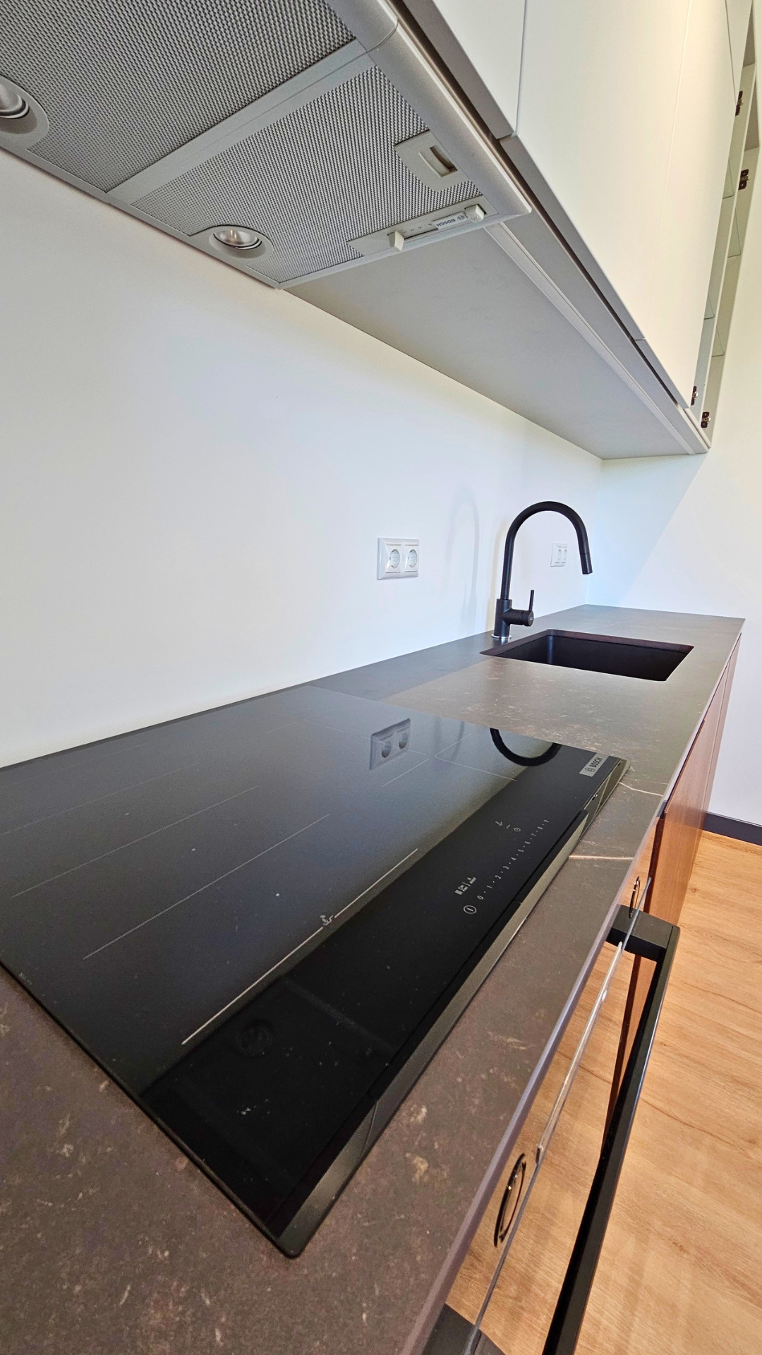 Finished kitchen inside a TheHouz modular home with Bosch induction hob and stone worktop
